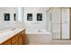 Bright bathroom featuring a soaking tub, shower, and double vanity at 598 Stonemont Dr, Castle Pines, CO 80108