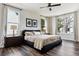 Inviting bedroom with dark wood floors, tray ceilings, and ample natural light at 598 Stonemont Dr, Castle Pines, CO 80108