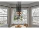 Bright dining area with large windows, modern chandelier, hardwood floors, and sleek design at 598 Stonemont Dr, Castle Pines, CO 80108