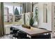 Well-lit dining room with a large wooden table and comfortable seating at 598 Stonemont Dr, Castle Pines, CO 80108