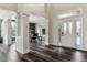 Inviting foyer with soaring ceilings, dark hardwood floors, and views into a stylish office at 598 Stonemont Dr, Castle Pines, CO 80108