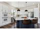 Spacious kitchen with a large island, pendant lighting, stainless steel appliances, and seating for three at 598 Stonemont Dr, Castle Pines, CO 80108