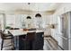 Modern kitchen with white cabinets, stainless steel appliances, and a central island with seating at 598 Stonemont Dr, Castle Pines, CO 80108