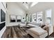 Bright living room with vaulted ceiling, large sectional sofa, hardwood floors, and natural light from large windows at 598 Stonemont Dr, Castle Pines, CO 80108
