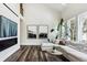 Bright living room featuring a sectional sofa and oversized windows at 598 Stonemont Dr, Castle Pines, CO 80108