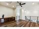 Bright loft area featuring dark wood floors and modern railings at 598 Stonemont Dr, Castle Pines, CO 80108