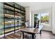 Bright home office with custom shelving and large windows offering natural light at 598 Stonemont Dr, Castle Pines, CO 80108