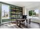 Stylish home office with custom shelving, two windows, and modern desk at 598 Stonemont Dr, Castle Pines, CO 80108