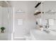 Bright bathroom featuring a single sink vanity, a toilet, modern lighting, and a glass-enclosed shower at 9490 W 14Th Ave # 3, Lakewood, CO 80215
