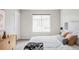 Bright bedroom with a large window, comfortable bed with a decorative headboard and stylish decor at 9490 W 14Th Ave # 3, Lakewood, CO 80215