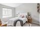 Bright bedroom with a large window, comfortable bed with a decorative headboard and stylish decor at 9490 W 14Th Ave # 3, Lakewood, CO 80215