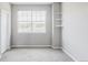 Empty room with neutral carpet, white walls, floating shelves and a large window at 9490 W 14Th Ave # 3, Lakewood, CO 80215