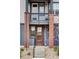 Charming townhouse front door with brick pillars and small upper balcony with view of house number at 9490 W 14Th Ave # 3, Lakewood, CO 80215