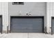 A gray garage door, highlighting the home's secure parking and exterior features at 9490 W 14Th Ave # 3, Lakewood, CO 80215
