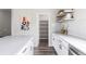 Bright kitchen with a view into pantry; features white countertops, cabinets, and floating shelves at 9490 W 14Th Ave # 3, Lakewood, CO 80215