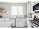 Close up on a sink, backsplash, cabinets, and countertop at 9490 W 14Th Ave # 3, Lakewood, CO 80215