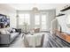 Inviting living area with gray sofa, modern art, large windows, and a doorway to the outside at 9490 W 14Th Ave # 3, Lakewood, CO 80215