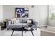 Comfortable living room with a gray sofa, modern art, area rug, and stylish decor at 9490 W 14Th Ave # 3, Lakewood, CO 80215