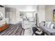 Bright open-concept living space features wood floors and a modern kitchen with stainless steel appliances at 9490 W 14Th Ave # 3, Lakewood, CO 80215