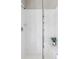 Shower featuring white tiles, modern shower head, and a clear glass door with a small plant at 9490 W 14Th Ave # 3, Lakewood, CO 80215
