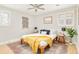 Well-lit bedroom featuring a ceiling fan, windows with shutters, and a vintage accent rug at 2972 Kearney St, Denver, CO 80207