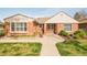 Charming brick home featuring a well-manicured lawn, inviting walkway, and pleasant curb appeal at 2972 Kearney St, Denver, CO 80207