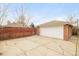 Detached two-car garage featuring a large concrete driveway and a red brick exterior at 2972 Kearney St, Denver, CO 80207