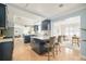 Bright kitchen with hardwood floors, sleek cabinetry, and a view into the adjacent sitting room at 2972 Kearney St, Denver, CO 80207