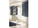 Stylish kitchen featuring blue cabinetry, modern countertops, and a convenient window for natural light at 2972 Kearney St, Denver, CO 80207