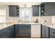 Modern kitchen with sleek blue cabinets, white subway tile, and stainless steel appliances at 2972 Kearney St, Denver, CO 80207