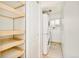 Laundry room with washer, dryer, built-in storage shelves, and a bright window at 2972 Kearney St, Denver, CO 80207