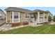 Beautiful backyard showcases a covered patio, lush lawn, and neat landscaping at 15211 Quince St, Thornton, CO 80602