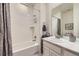 Bathroom featuring a shower-tub combo with decorative fixtures and stylish white tiling at 15211 Quince St, Thornton, CO 80602