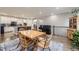 Bright dining area featuring a hardwood floors and a seamless transition to the kitchen at 15211 Quince St, Thornton, CO 80602