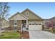 Charming home with a stone facade, a two-car garage, and a beautifully landscaped front yard at 15211 Quince St, Thornton, CO 80602