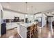 Modern kitchen features a granite island, stainless steel appliances, and ample cabinet space at 15211 Quince St, Thornton, CO 80602