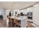 Stylish kitchen with an island, pendant lighting, and modern stainless steel appliances at 15211 Quince St, Thornton, CO 80602