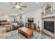 Cozy living room showcasing a fireplace, hardwood floors, and comfortable seating at 15211 Quince St, Thornton, CO 80602