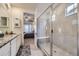 Main bathroom boasts a walk-in glass shower with a built-in bench and neutral tile at 15211 Quince St, Thornton, CO 80602