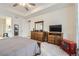 Main bedroom features a dresser, TV, and access to the ensuite bathroom at 15211 Quince St, Thornton, CO 80602