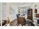 Office with wooden desk, bookshelf, and natural light from the window at 15211 Quince St, Thornton, CO 80602