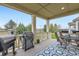 Covered patio features an outdoor dining area and grill, ideal for entertaining at 15211 Quince St, Thornton, CO 80602