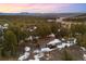 Aerial view of a home nestled among pine trees, showcasing the natural beauty of the surrounding landscape at 2859 Cagle Dr, Larkspur, CO 80118