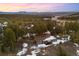 Aerial view of a lovely home nestled in a wooded area with a long driveway at 2859 Cagle Dr, Larkspur, CO 80118