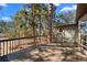 Outdoor deck with patio furniture surrounded by mature trees at 2859 Cagle Dr, Larkspur, CO 80118