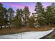 Inviting home exterior featuring a spacious backyard and lush trees at 2859 Cagle Dr, Larkspur, CO 80118