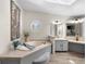 Luxurious bathroom with large tub, octagon window, and vanity with double sinks at 2859 Cagle Dr, Larkspur, CO 80118