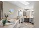 Bright bathroom with a soaking tub, double vanities, and a skylight at 2859 Cagle Dr, Larkspur, CO 80118