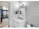 Modern bathroom featuring a white vanity, and shiplap wall design at 2859 Cagle Dr, Larkspur, CO 80118