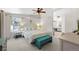 Bright bedroom featuring neutral tones, a tufted headboard, and an ensuite bathroom at 2859 Cagle Dr, Larkspur, CO 80118